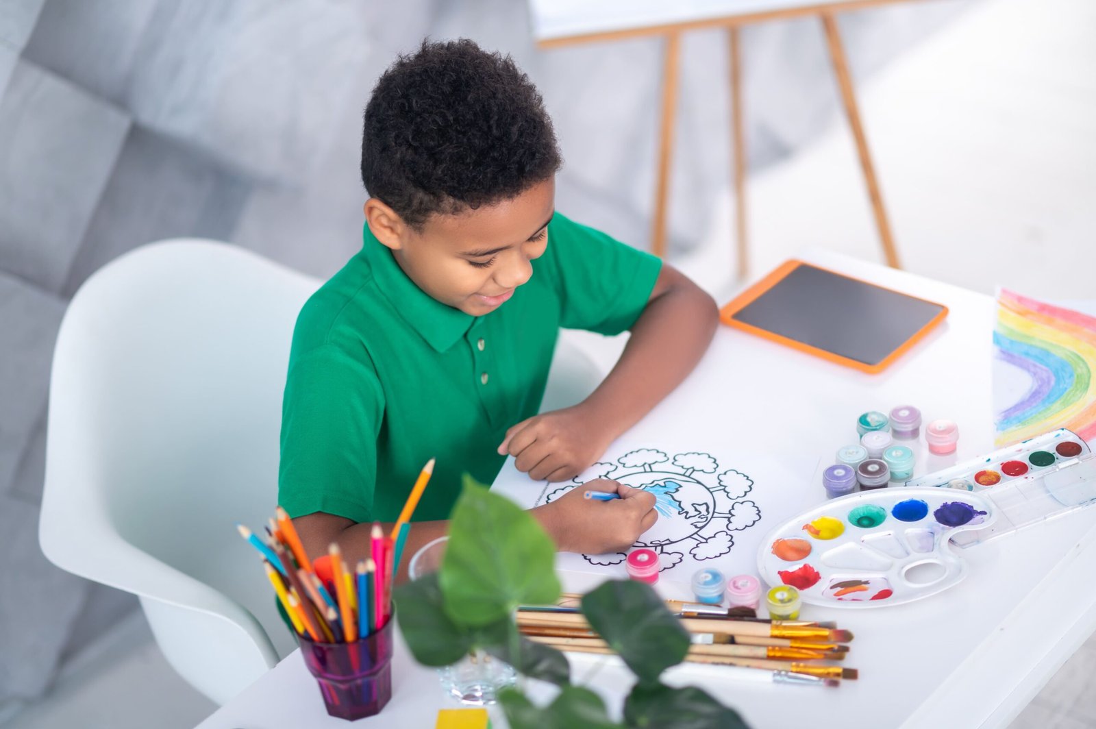 top view joyful boy drawing with crayons scaled